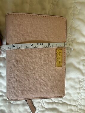 kate spade pale pink textured leather passport cover with gold plaque